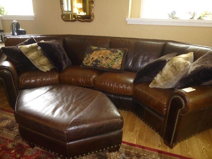 BROWN CURVED LEATHER SECTIONAL WITH OTTOMAN 