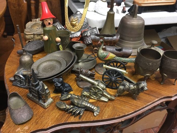 Vintage brass cannons, bells, plates, and more