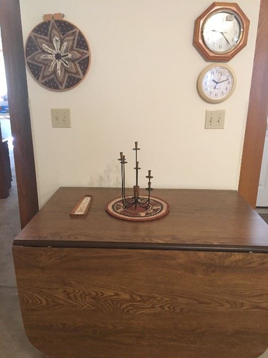 large drop-leaf dining table with 4 leaves, clocks