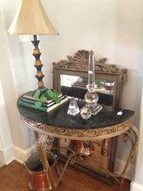 The marble top demilune table has the matching mirror. 