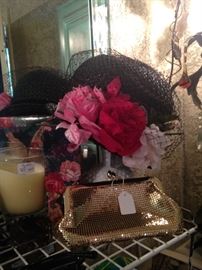 Flowers adorning a black hat; Whitening and Davis evening bag