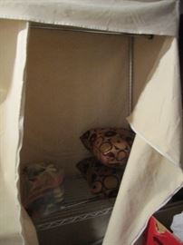 CUSHIONS IN A METAL/CANVAS ENCLOSED STORAGE UNIT FROM CONTAINERS AND MORE