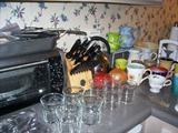 Kitchen stuff - drinking glass sets, toaster oven, there are two microwaves, great large coffee urn, good knife set by Kitchen Aid.....