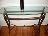 One of a pair of demi-lune side tables with heavy beveled glass.