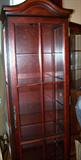 Lighted display curio cabinet with glass shelves.