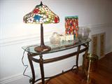 We have two of these tables - this is the same lamp from above (lit up) - note the cute painting obtained in Haiti on one of the owner's trips - nice crystal champagne bucket.