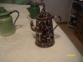 A sampling of enamelware coffee pots.  There are over 90