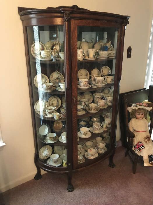 Antique Oak Bow Front Chain Cabinet , large collection of vinta , antique doll and chairge cups and saucers 