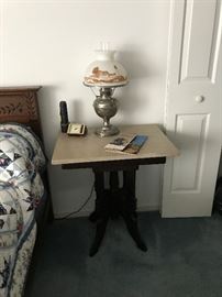 Antique Eastlake table with marble top and vintage lamp