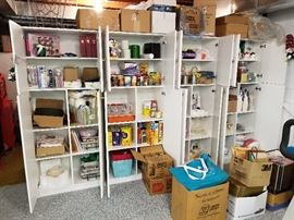 Formica shelving stuffed to overflowing...Vintage VHS tapes childrens unopened, Temptations Cookware/serving pieces brand new, New Basket set, Food, Collectible Sports stadium statues boxed, vintage Tupperware, etc