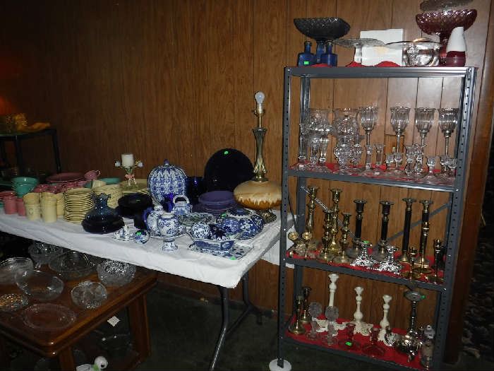Many fine candlesticks and also many candles in another room. Everything marked to sell quick!