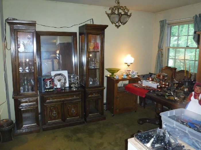 This Broyhill 1970's China cabinet had to come apart to move and I it became even better. There is now a small buffet table, 2 independent lighted cabinets that can go flush against a wall, a nice size mirror and off to the side the header piece if anyone still wants to re-join them.