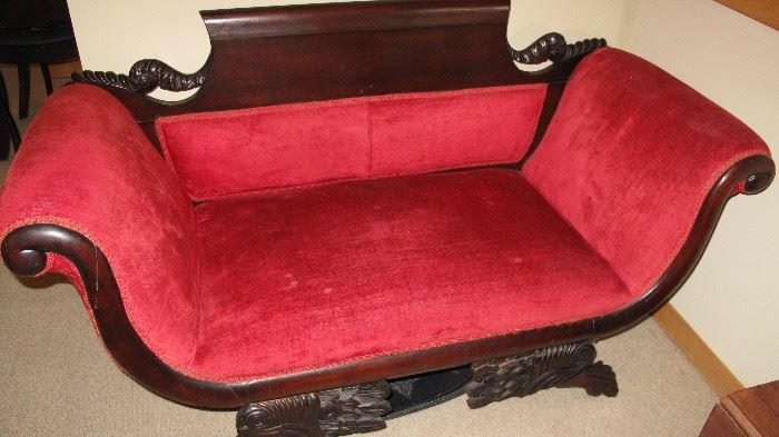 Ornate carving on this early loveseat.