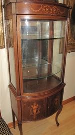 Inlaid curved front vitrine.