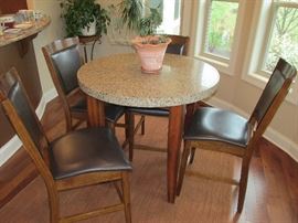 Granite pub table with leather and wood chairs