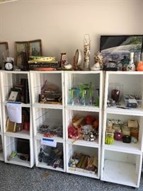 About 40 of these white storage boxes - they have doors which were removed for the sale.  We ask that these  be picked up on Saturday!  Frames, Candles, plastic glasses for summer parties, batteries, puzzles.