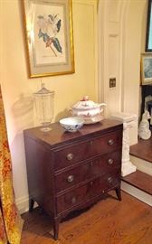 Classic, small chest of drawers -- needs some veneer replacement & work -- priced accordingly. Ornate marble pedestal to the right; porcelain tureen, large antique glass jar; Asian bowl. 