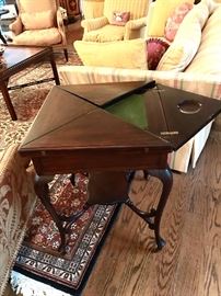 Game table with 4 flaps that open.  Needs a little restoration. 