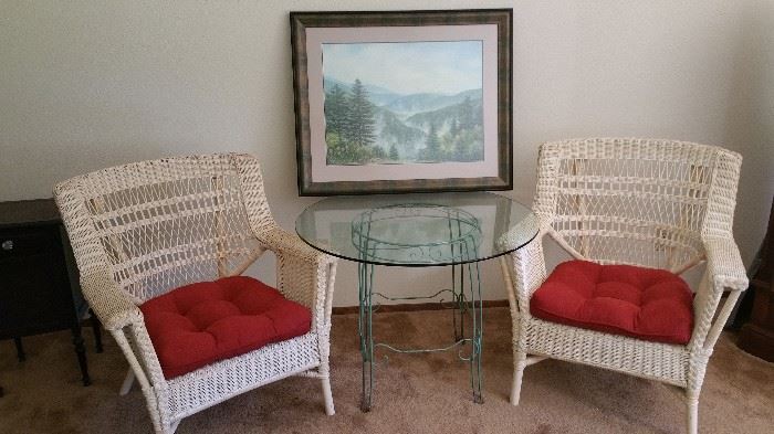 pair of wicker chairs - glass top table with cool painted metal base - large landscape print
