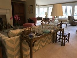 Beautiful sofa and loveseat with a sofa table full of crystal