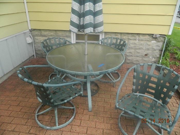outdoor table with chairs and umbrells