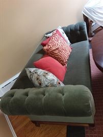 Sofa with tufted arms