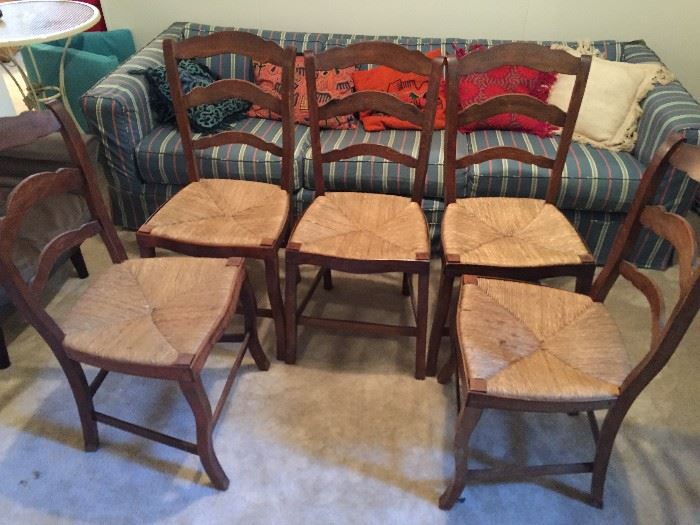 Five matching cane chairs.