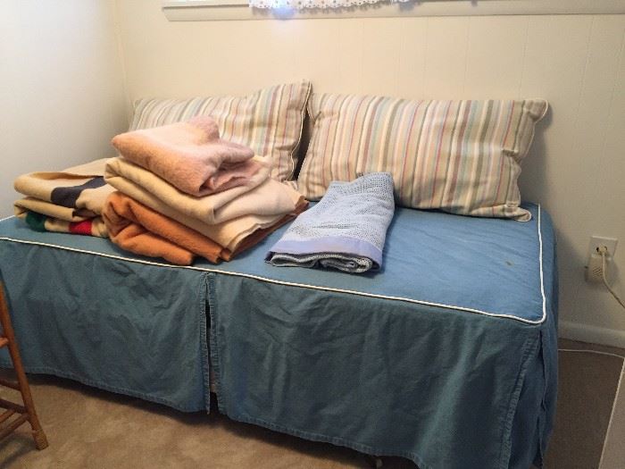 Day bed with assorted blankets.
