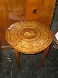 elaborate marquetry side table with chariot at center