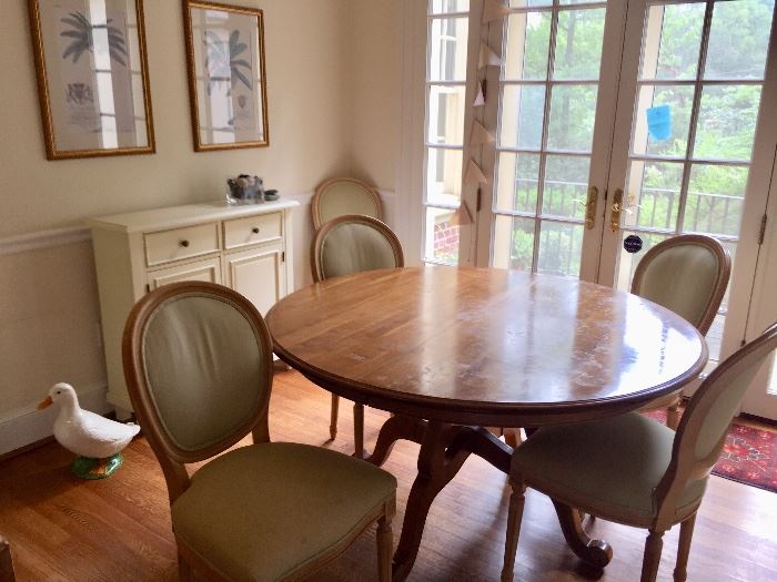 Pedestal table with two leaves.  Six upholstered chairs.