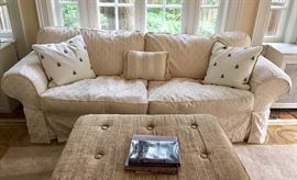 Slip covered rolled arm sofa bed.