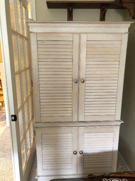 Armoire that will hold a TV and/or clothing, bedding, pillows. Distressed wood is a good look in almost any room. 