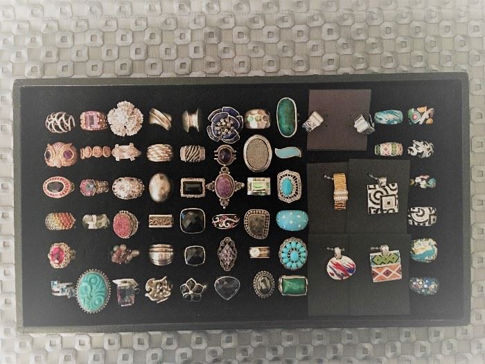A variety of sterling silver rings with a variety of stones including cubic zirconia, druzy quartz, onyx, amethyst, turquoise and more. The sterling silver enamel and cubic zirconia pieces on the right side are designer Belle Etoile. All 50% off!