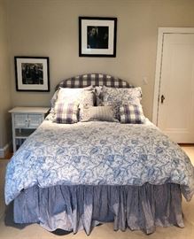 Plush upholstered headboard mounts to the wall. Fabulous linens!
