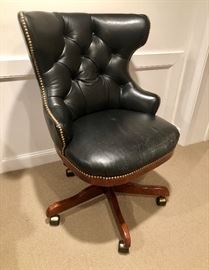 Leather button-tufted executive swivel/tilt chair with nail head trim. 