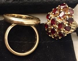 Gold wedding bands and gold and garnet ring.