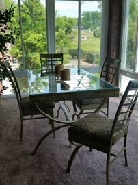 Beautifully painted aluminum frame glass top table and four matching upholstered seat chairs