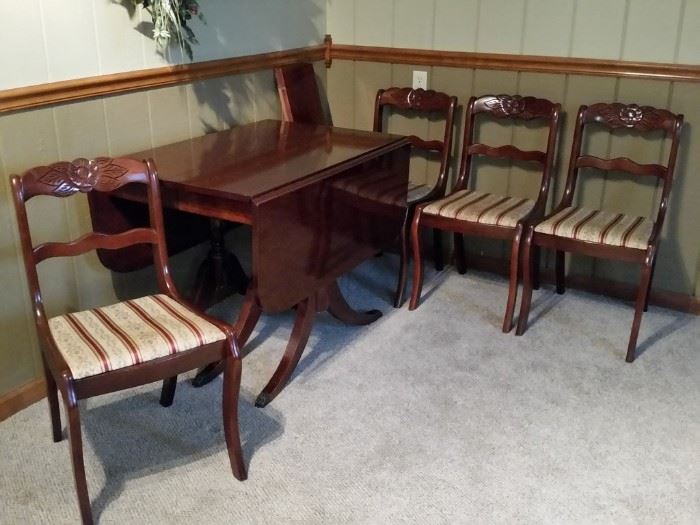 Duncan Phyfe mahogany drop leaf table with two extra leaves.  Four carved mahogany chairs.
