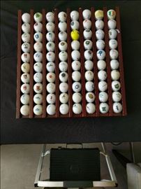 Mahogany ball display with 80 different golf balls