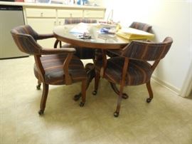 $395 42" Round glass top table with 4 chairs on casters