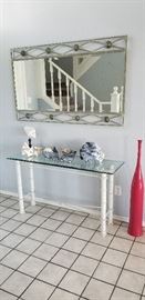 glass entry table, coral specimens, metal and glass mirror