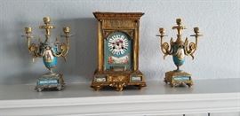 Rare find Porcelain and heavy cast gilt clock and candelabra pair