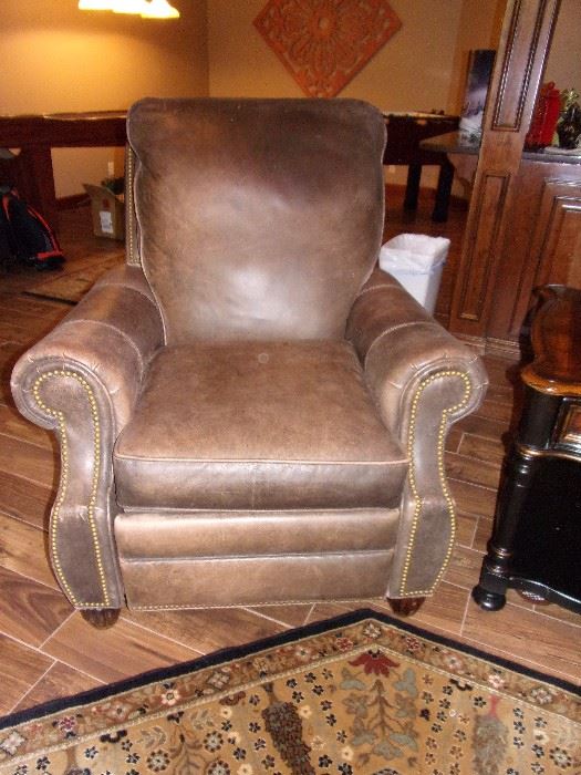 Two matching Leather Motion Craft by Sherrill, three way low leg recliner with nail head trim  fully reclining chairs, beautiful area rug and one of two Seven Seas by Hooker end tables with drawer