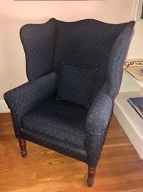 Upholstered wing-back arm chair.
