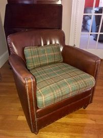 Love this leather chair from Anthropologie! Features nailhead trim and green plaid cushion.