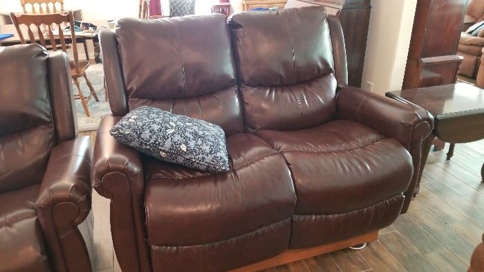 Motorized raised leather love seat recliners