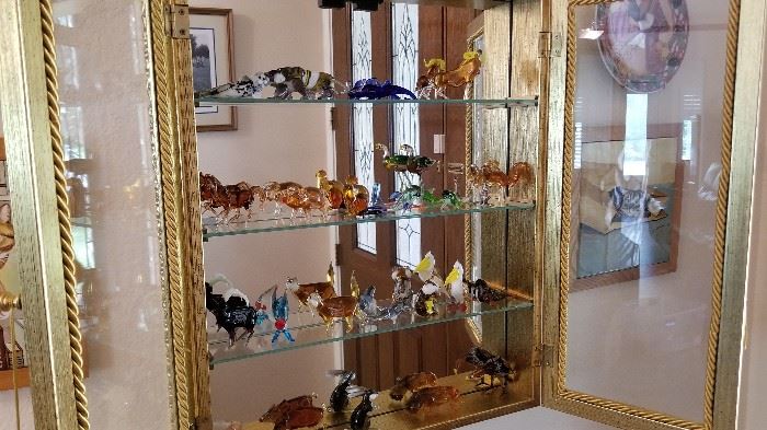 Glass display case with figurines