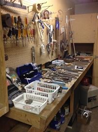 Basement toolroom filled to brim with handtools and supplies