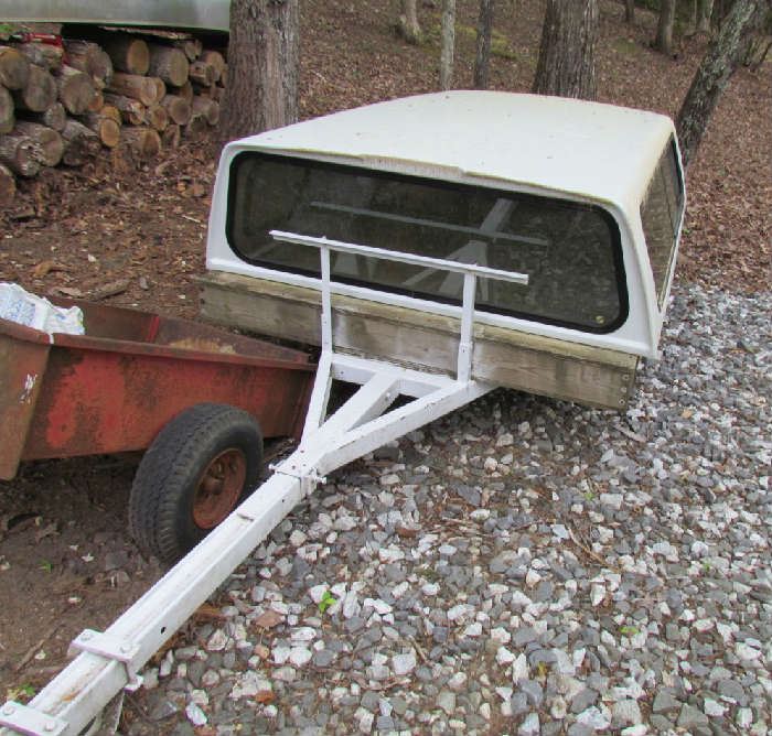 Trailer is separate, and can be used for boat or for hauling on flat platform.  Cover is from GMC pickup.  