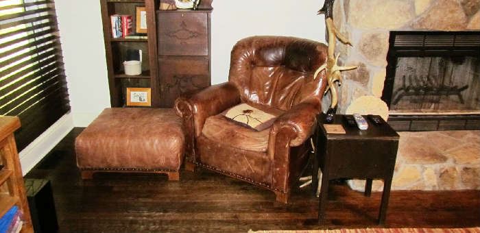 Aged leather armchair with matching hassock